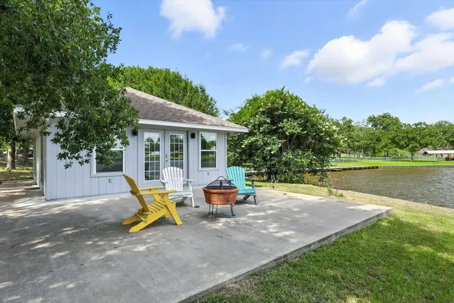 a backyard of a house with table and chairs