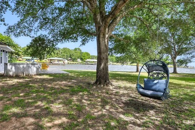 a backyard of a house with a fountain table and chairs