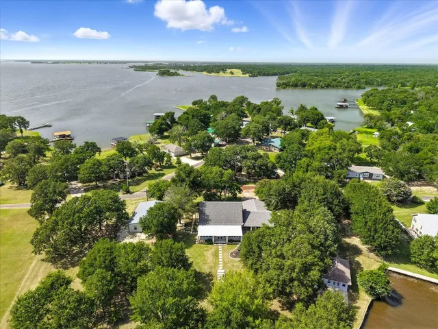 an aerial view of a houses with a lake view