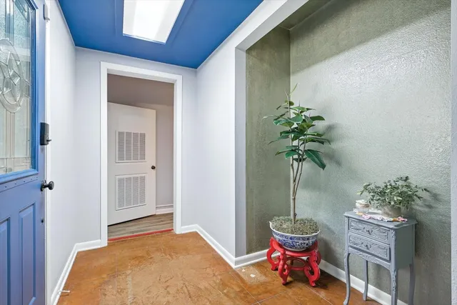 a living room with furniture and potted plant