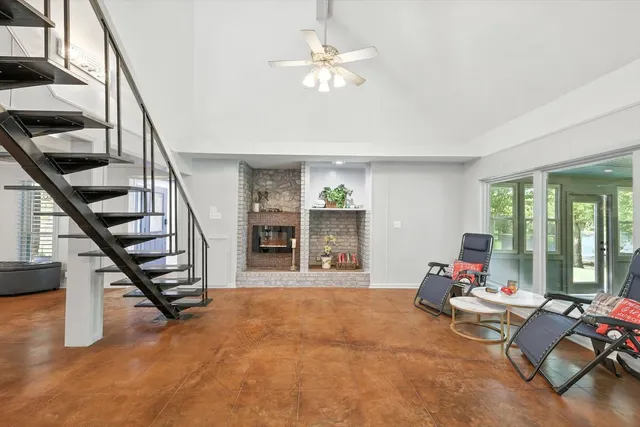 a living room with furniture and large windows