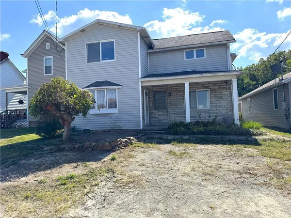 a front view of a house with a yard