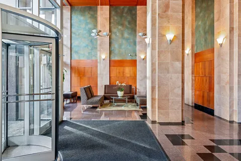 a building outdoor space with patio furniture and glass door