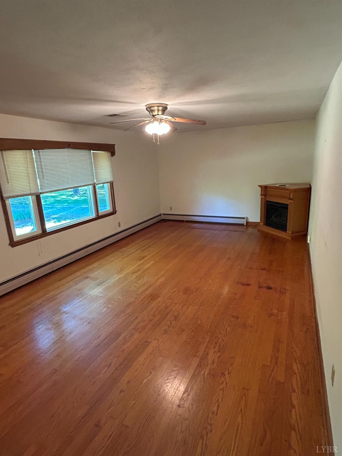 465 Wileman Road Lynch Station, VA 24571 - Photo 8 of 45 a view of an empty room with window and wooden floor
