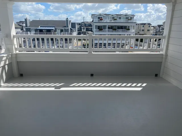 a kitchen with stainless steel appliances kitchen island granite countertop a table chairs sink and wooden floor