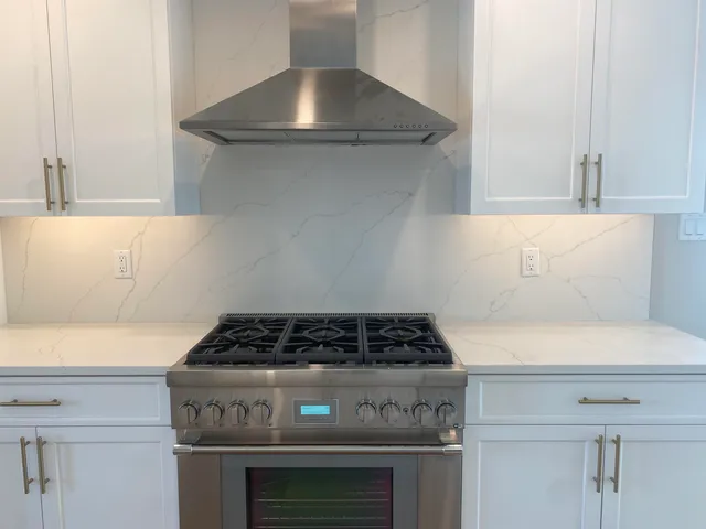 a kitchen with a stove and a refrigerator