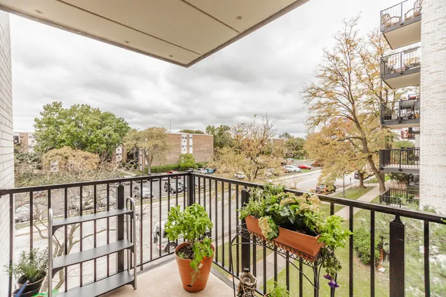 a view of a balcony with wooden fence