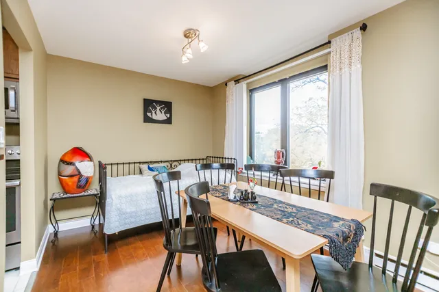 a view of a dining room with furniture and wooden floor