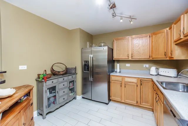 a kitchen with stainless steel appliances granite countertop a stove a sink dishwasher and a refrigerator