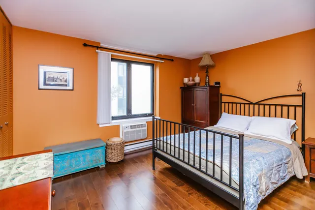 a bedroom with bed and a window