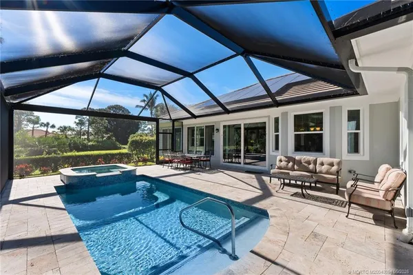 an aerial view of a house with swimming pool and garden