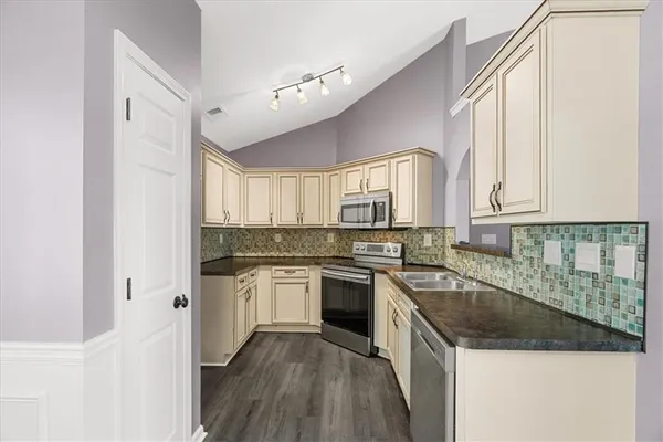 a kitchen with a sink stove and cabinets