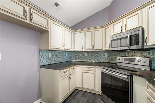 a kitchen with stainless steel appliances granite countertop a sink and dishwasher a stove microwave oven with cabinets