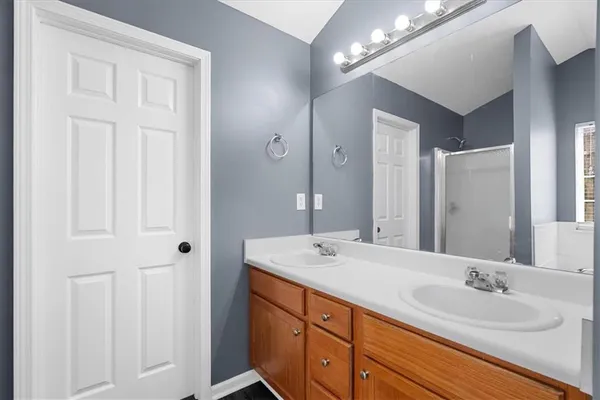 a bathroom with double vanity sinks and a mirror