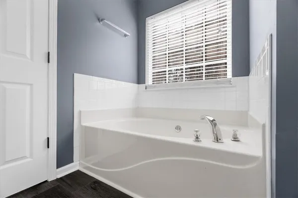 a bathroom with a bathtub and a window