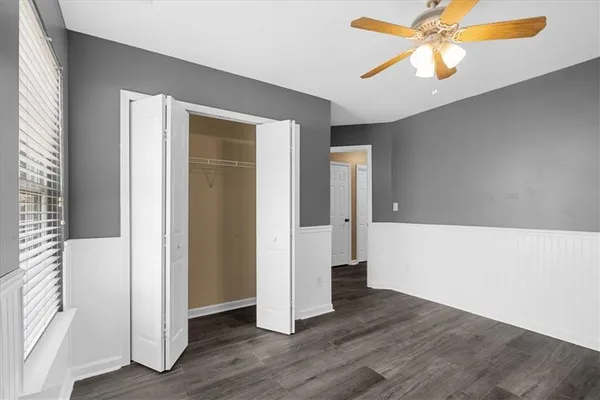 a view of empty room with wooden floor