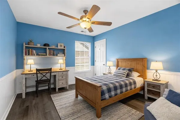 a bedroom with a bed and a chandelier