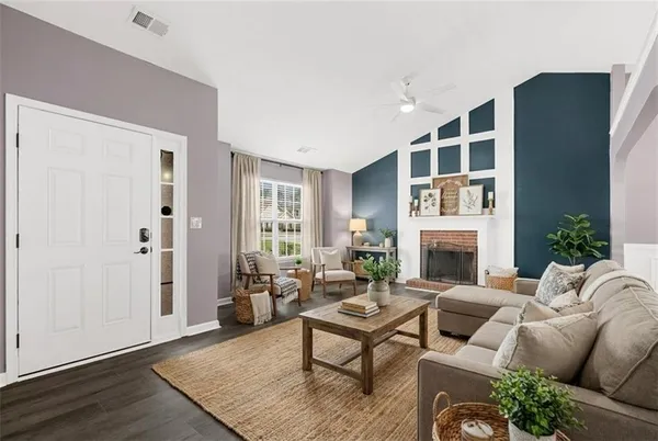 a living room with furniture a fireplace and a window