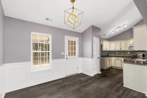 a view of a kitchen with a sink a refrigerator and window
