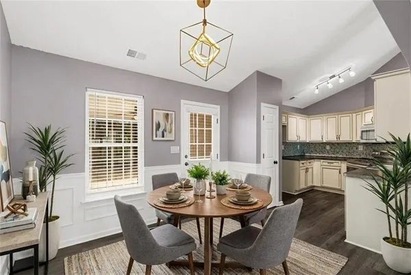a view of a dining room with furniture window and wooden floor