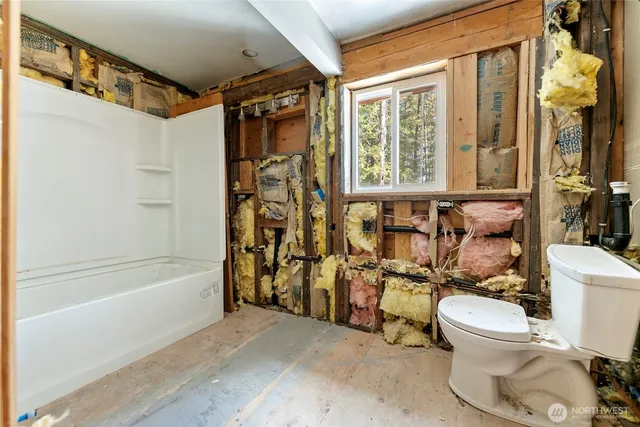 a bathroom with a toilet sink and a shower curtain
