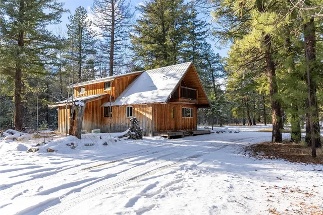 a front view of a house with a yard covered in snow