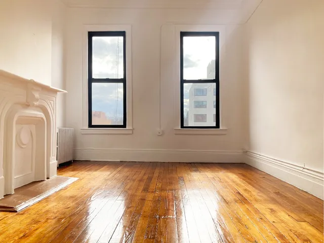 an empty room with windows and closet