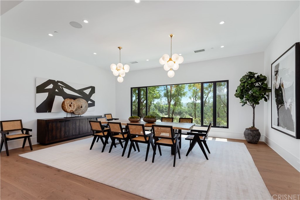 5757 Hoback Glen Road Hidden Hills, CA 91302 - Photo 12 of 47 a dining room with furniture a chandelier and a rug