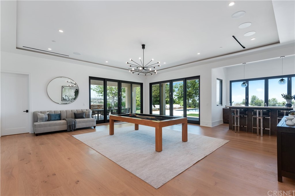 5757 Hoback Glen Road Hidden Hills, CA 91302 - Photo 13 of 47 a living room with furniture a window and a chandelier