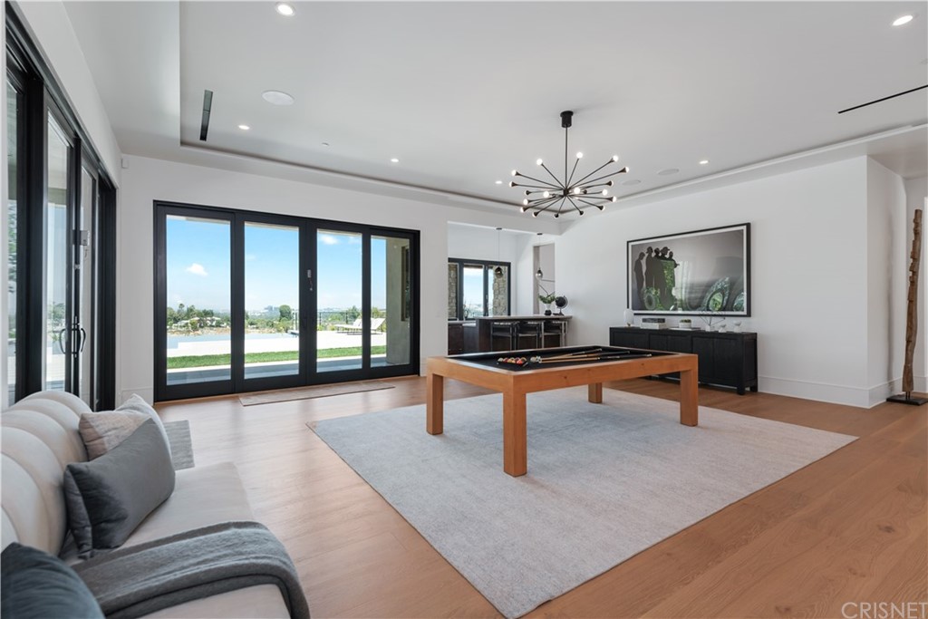 5757 Hoback Glen Road Hidden Hills, CA 91302 - Photo 14 of 47 a living room with furniture a rug and a large window
