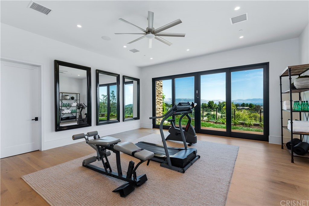 5757 Hoback Glen Road Hidden Hills, CA 91302 - Photo 16 of 47 a living room with furniture and floor to ceiling window