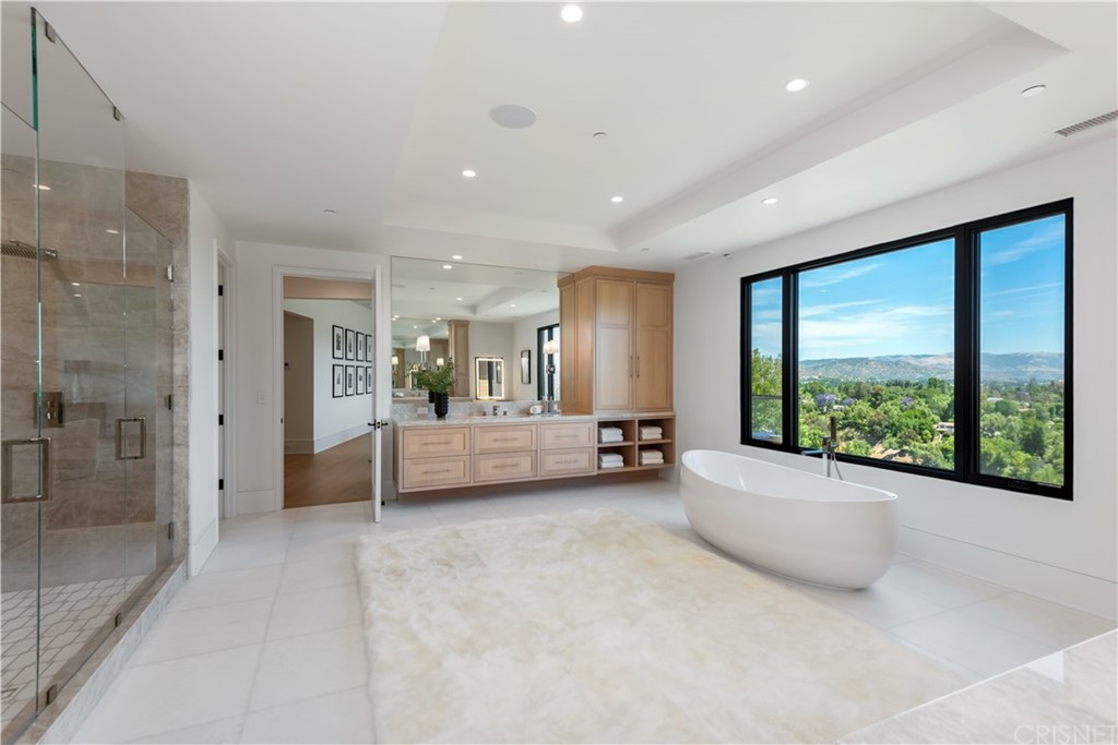 5757 Hoback Glen Road Hidden Hills, CA 91302 - Photo 24 of 47 a view of a bedroom with a large window and bed