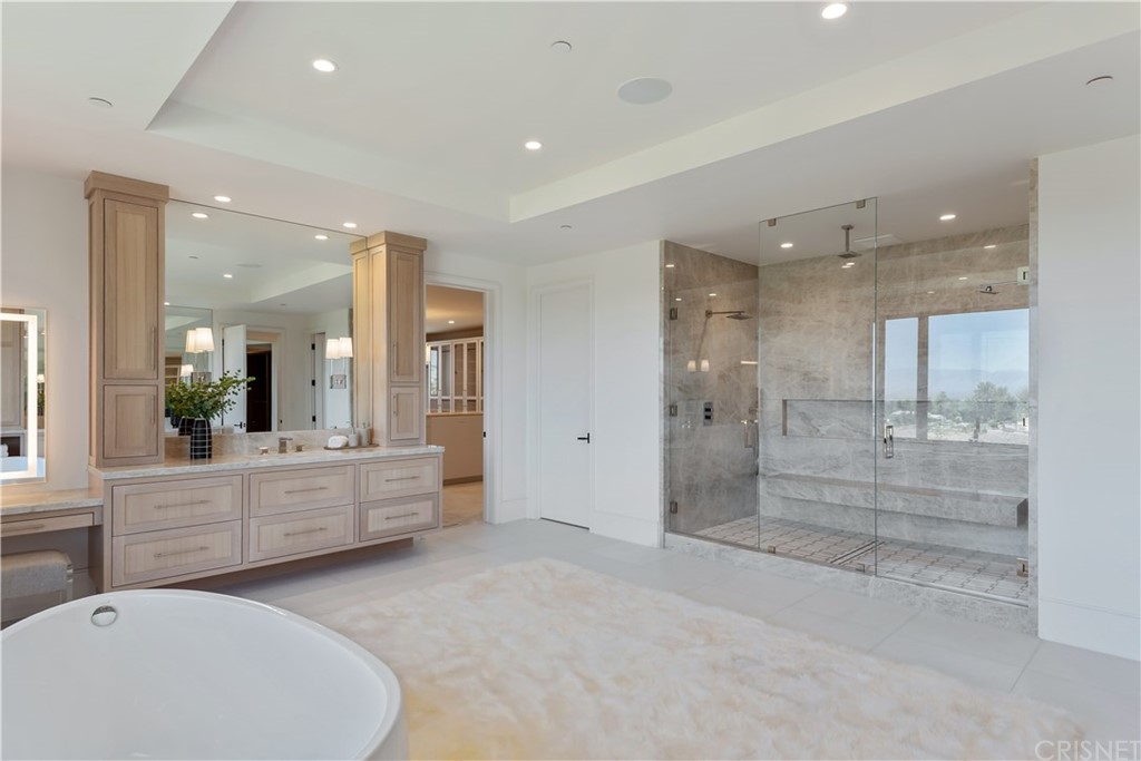 5757 Hoback Glen Road Hidden Hills, CA 91302 - Photo 25 of 47 a bathroom with a tub shower and sink