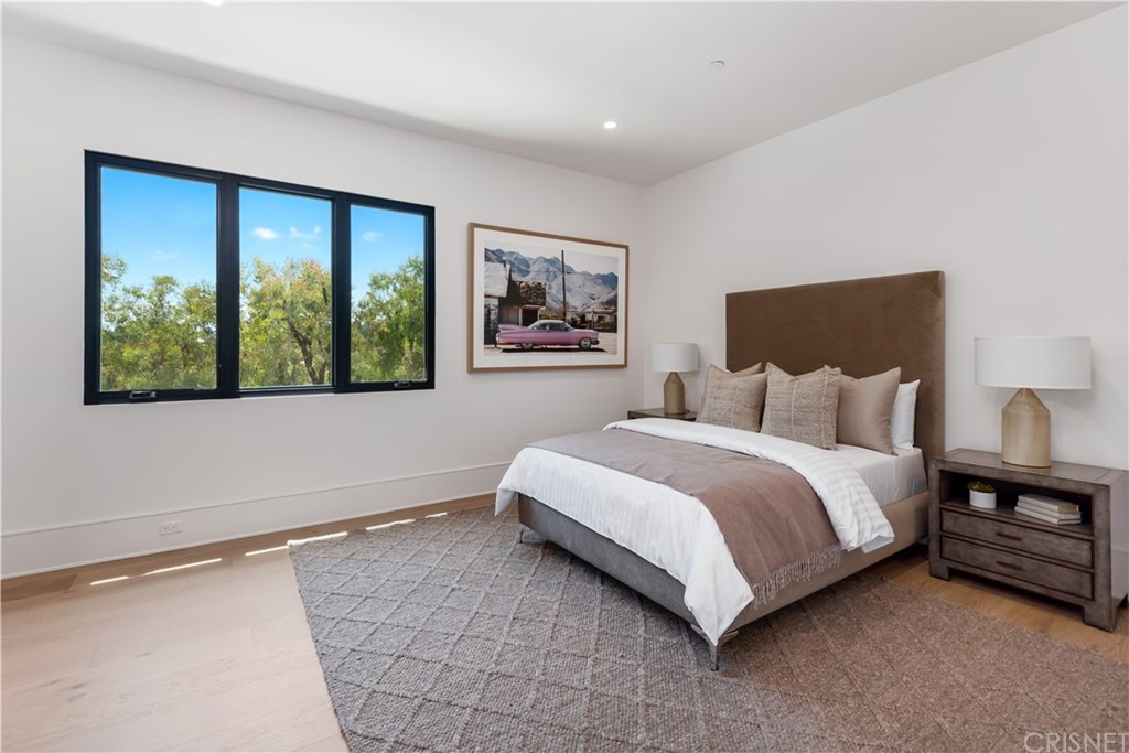 5757 Hoback Glen Road Hidden Hills, CA 91302 - Photo 28 of 47 a bedroom with a large bed and a large window