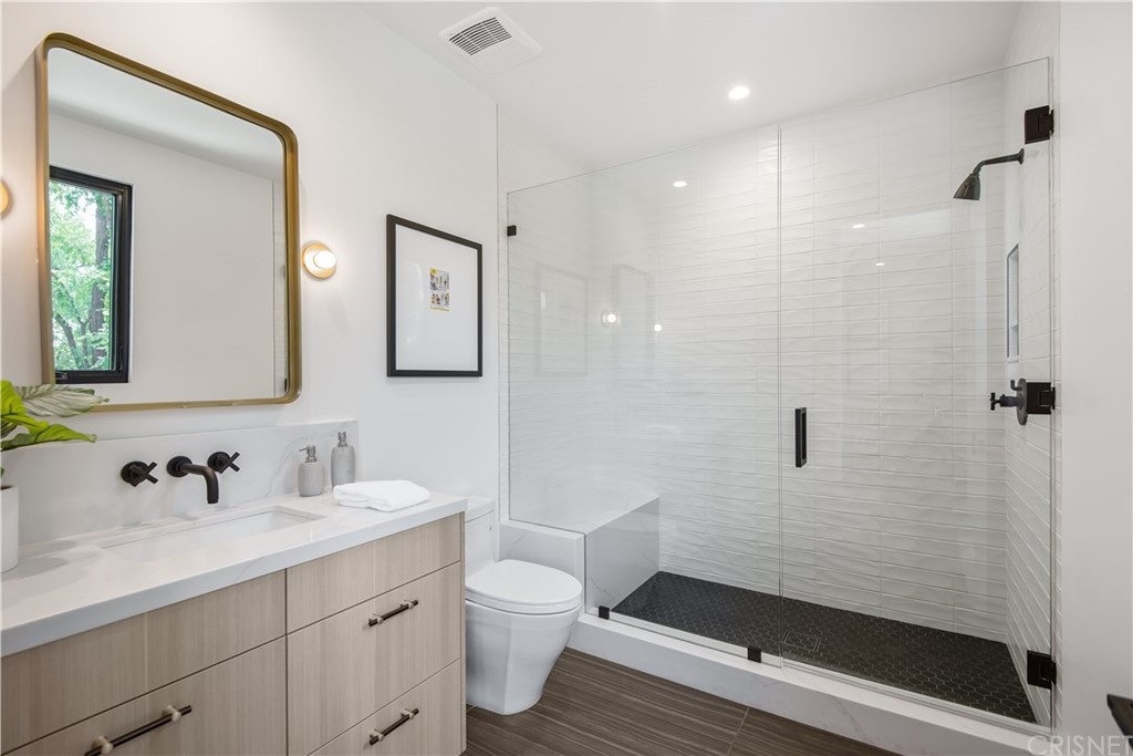 5757 Hoback Glen Road Hidden Hills, CA 91302 - Photo 29 of 47 a bathroom with a sink a toilet a mirror and shower