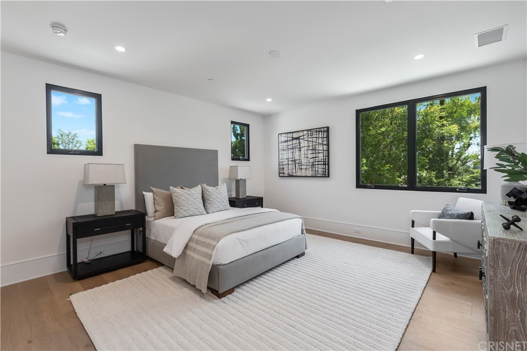 5757 Hoback Glen Road Hidden Hills, CA 91302 - Photo 30 of 47 a bedroom with a large bed and a couch