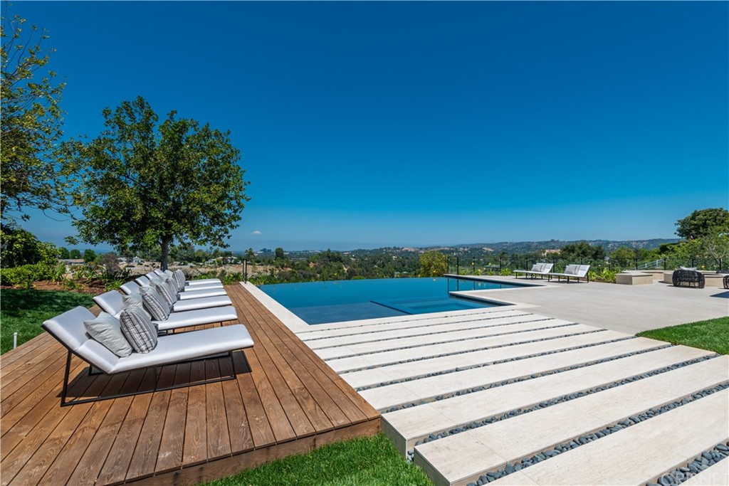 5757 Hoback Glen Road Hidden Hills, CA 91302 - Photo 35 of 47 a view of a terrace with couches and city view