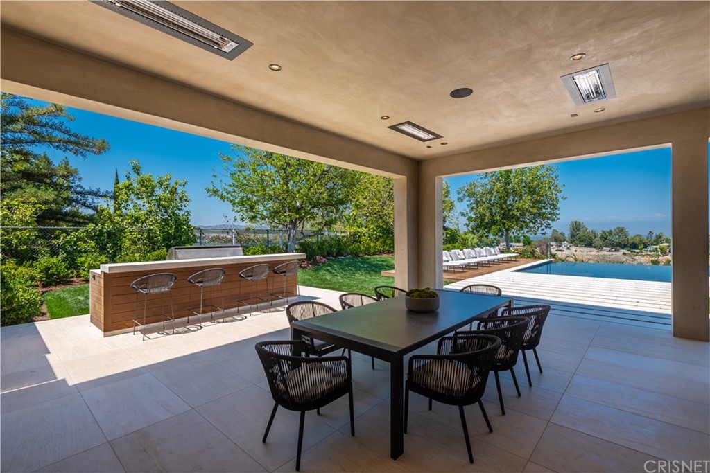 5757 Hoback Glen Road Hidden Hills, CA 91302 - Photo 37 of 47 a view of a patio with a table and chairs