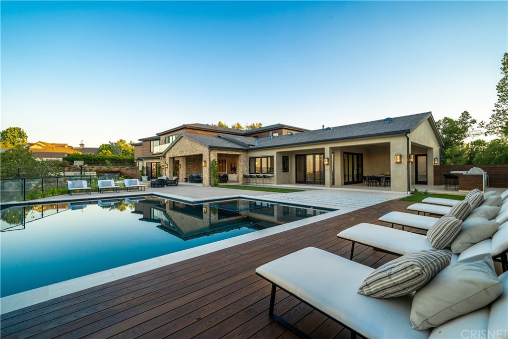 5757 Hoback Glen Road Hidden Hills, CA 91302 - Photo 41 of 47 a balcony with wooden floor table and chairs