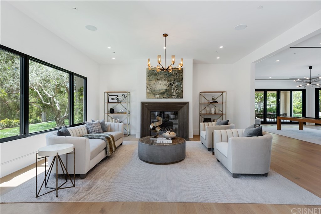 5757 Hoback Glen Road Hidden Hills, CA 91302 - Photo 8 of 47 a living room with fireplace furniture and a large window