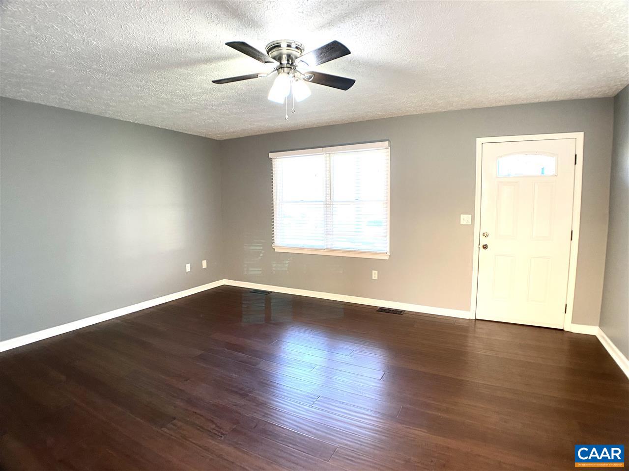 147 Buckboard Road Waynesboro, VA 22980 - Photo 2 of 25 an empty room with wooden floor and windows