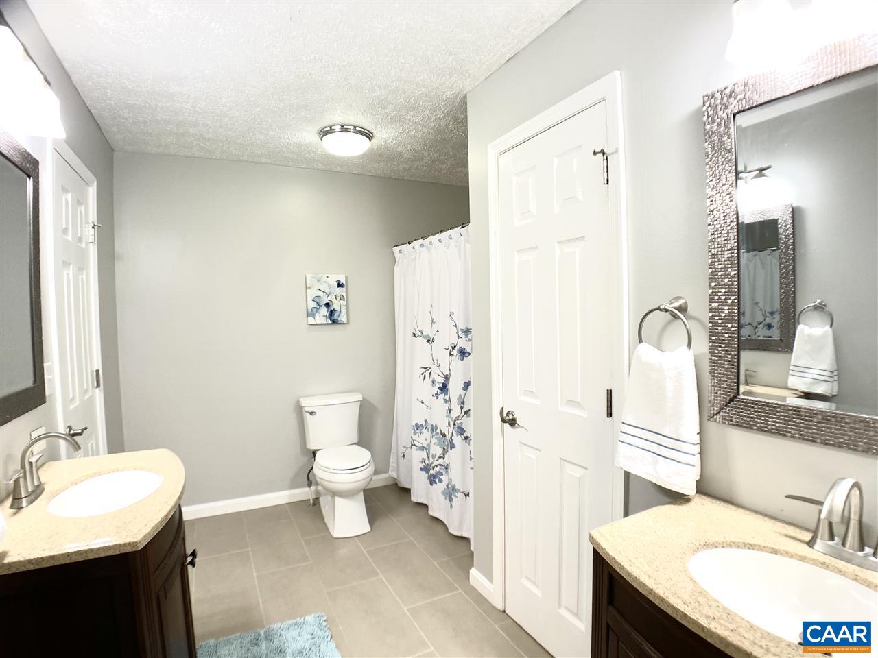 147 Buckboard Road Waynesboro, VA 22980 - Photo 10 of 25 a bathroom with a granite countertop sink toilet and shower