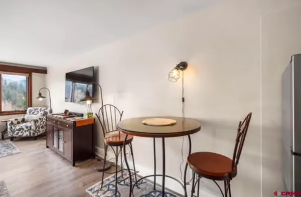 a kitchen with a sink cabinets and a wooden floor