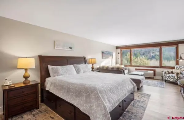 a bedroom with a large bed and a large window