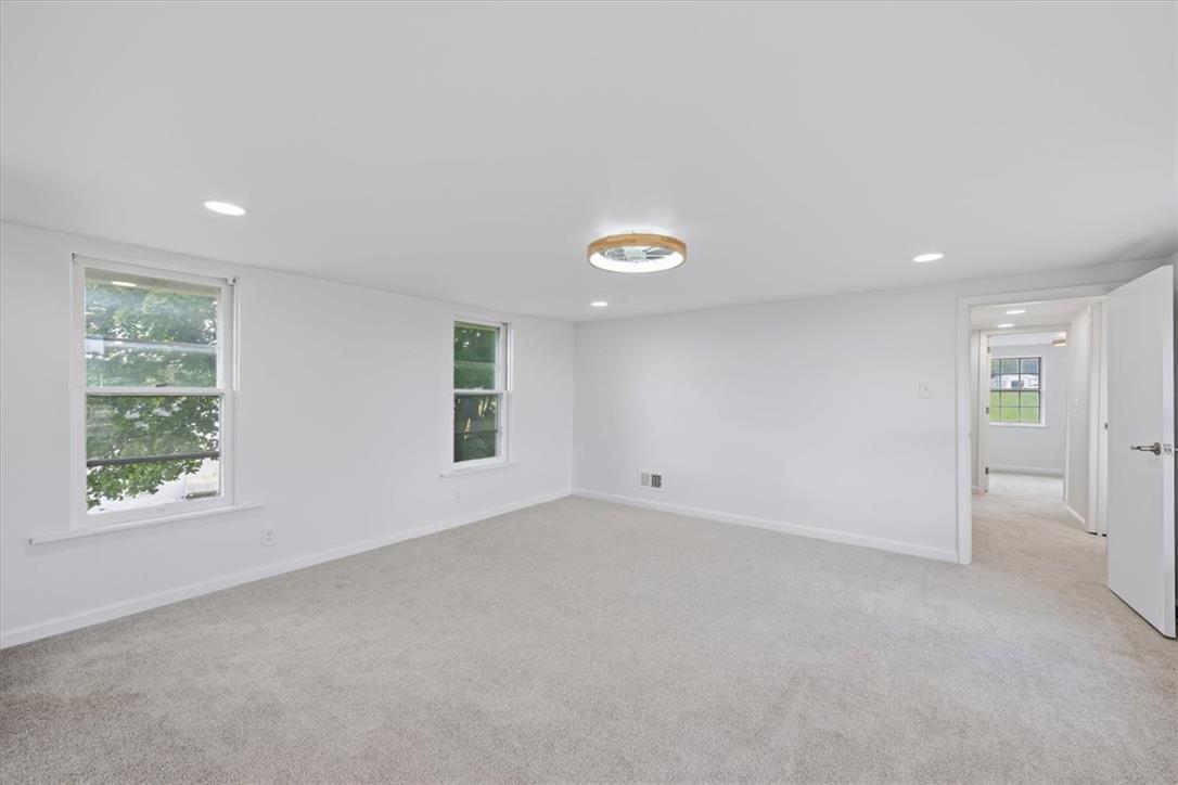2412 Clearview Road Coplay, PA 18037 - Photo 15 of 53 Soft carpeting pairs with recessed lighting to create a clean, minimalist interior aesthetic.