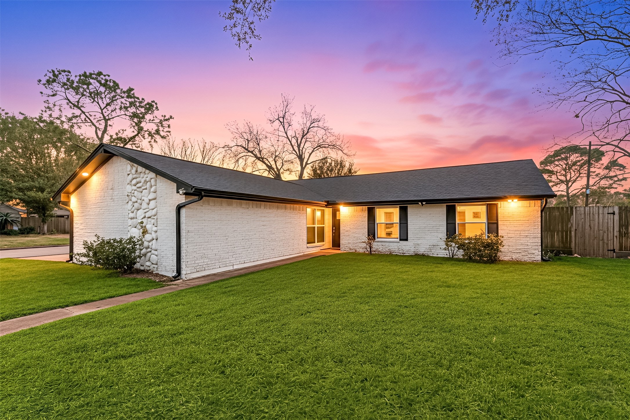 a backyard of a house with lots of green space and fountain