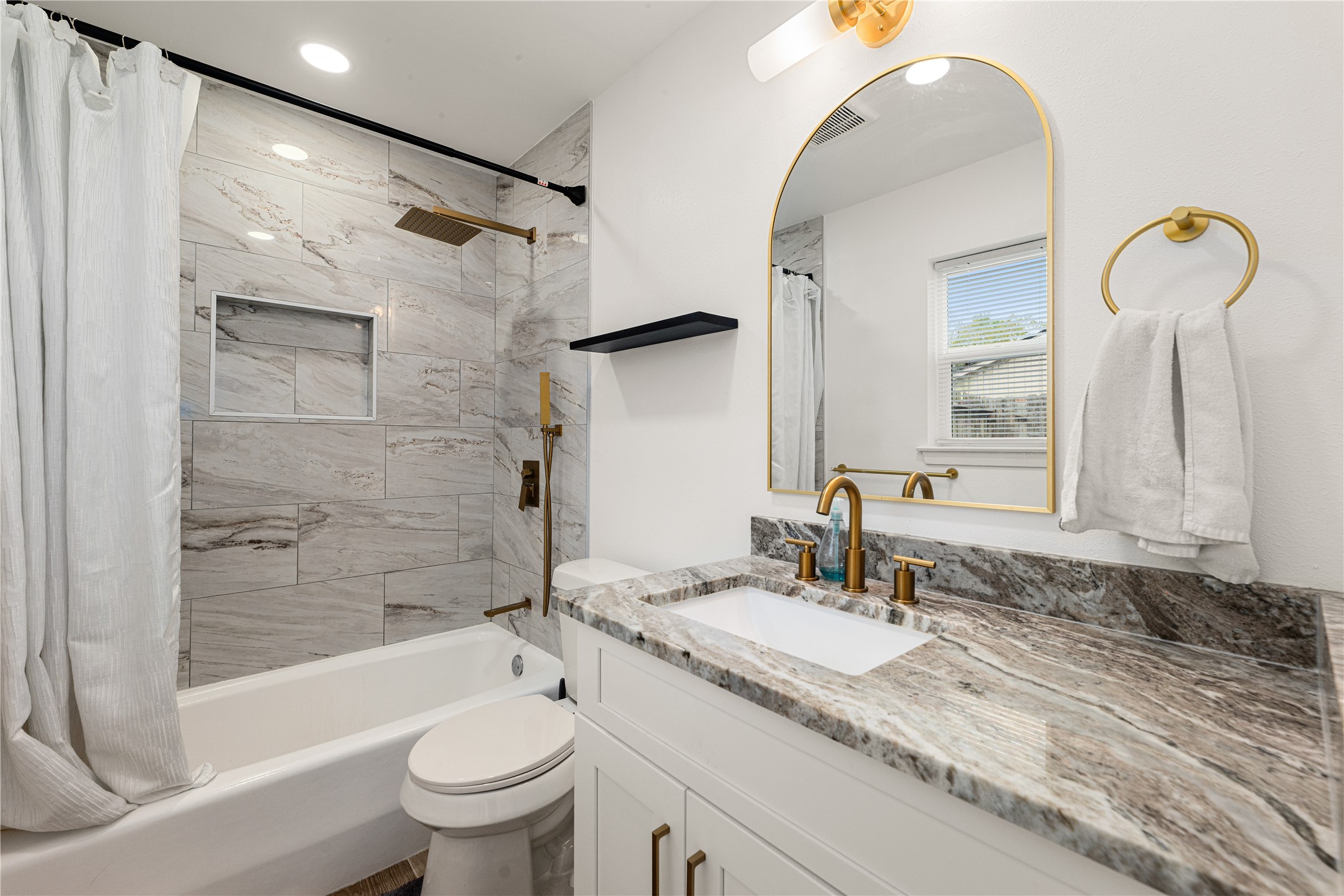 3410 Tanglewilde Street Houston, TX 77063 - Photo 12 of 17 a bathroom with a granite countertop sink toilet and shower