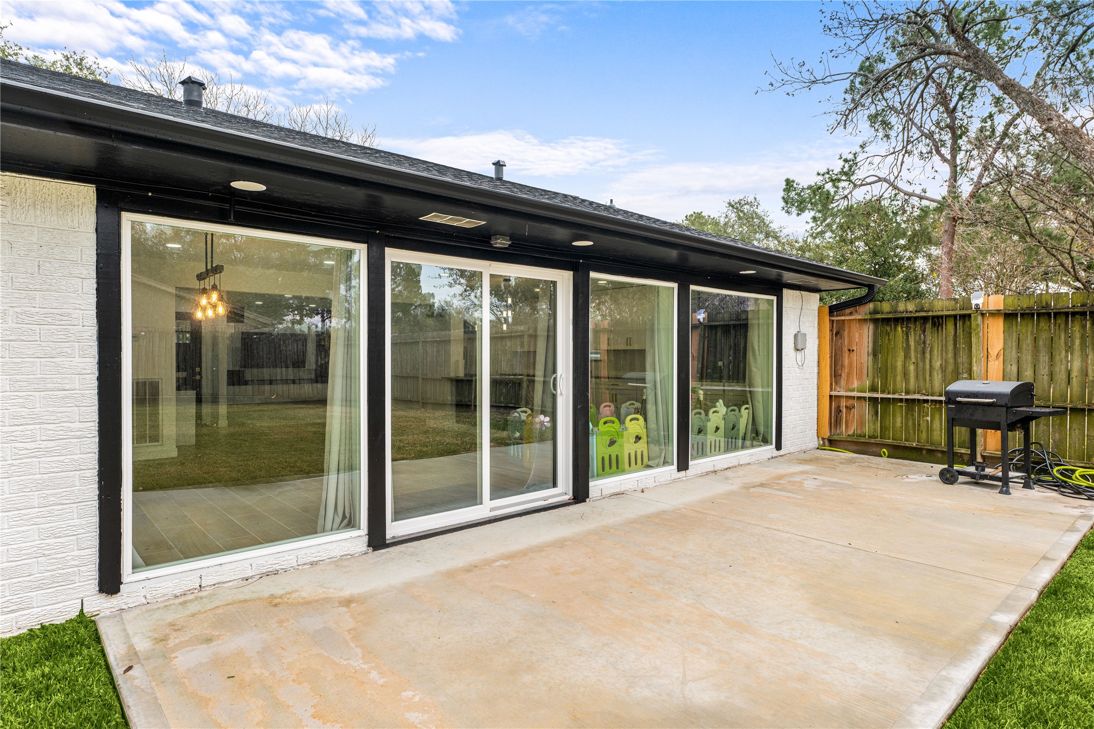 3410 Tanglewilde Street Houston, TX 77063 - Photo 16 of 17 a backyard of a house with table and chairs