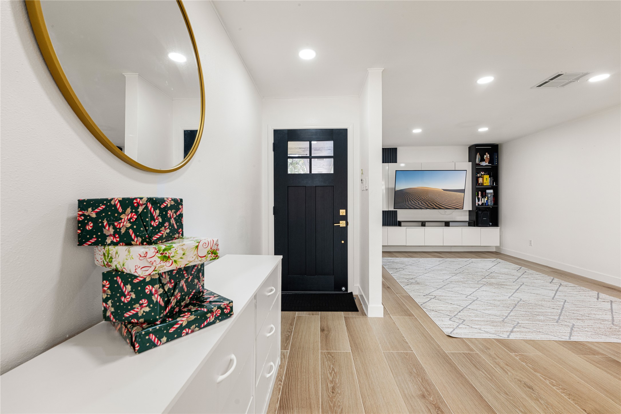 3410 Tanglewilde Street Houston, TX 77063 - Photo 3 of 17 a living room with furniture and a mirror