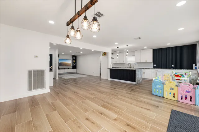 a view of a kitchen with kitchen island and stainless steel appliances